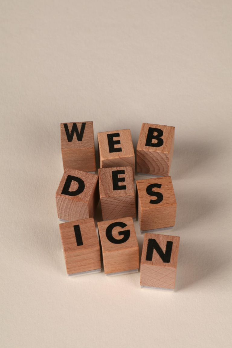 Wooden blocks arranged to spell 'Web Design'. Perfect for creative, digital content themes.